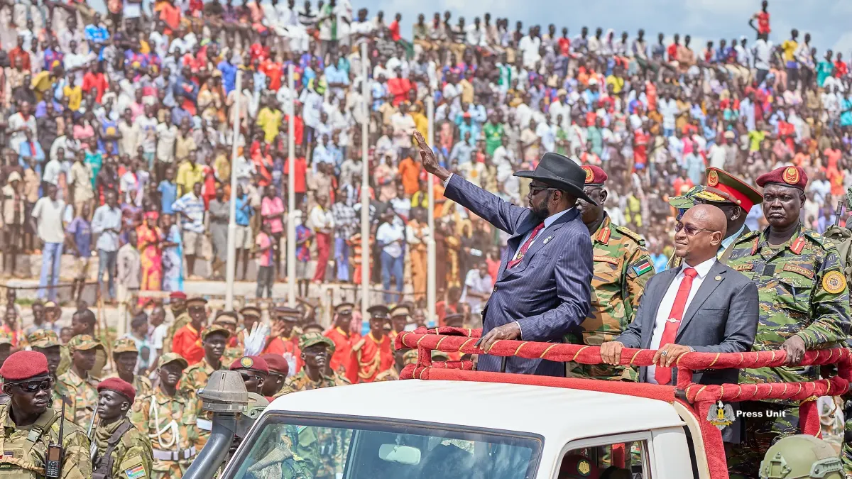 The Chairman waves to a packed stadium during national celebrations.